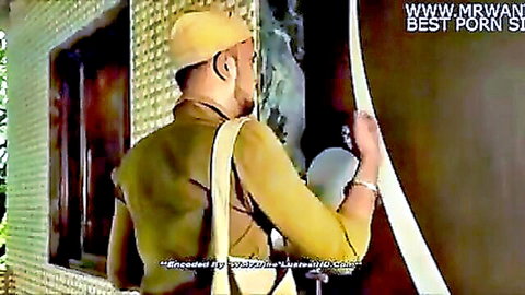 Indian man in turban and khaki uniform holding white cloth outside, Bewafa Bibi scene