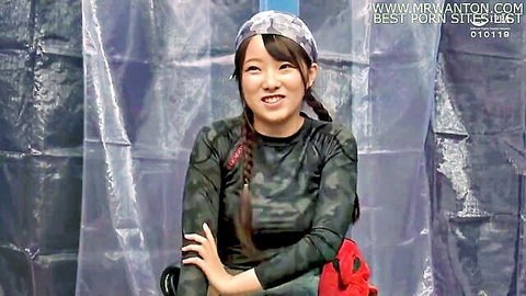Cute Asian amateur smiling in camo top and braids