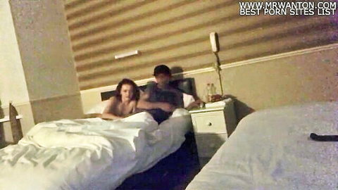 Laura giving passionate blowjob to man in intimate hotel setting