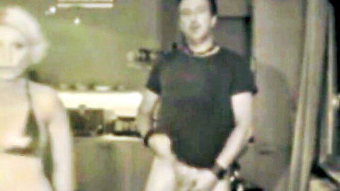 Blonde woman dances seductively with Asian man in fun cam show