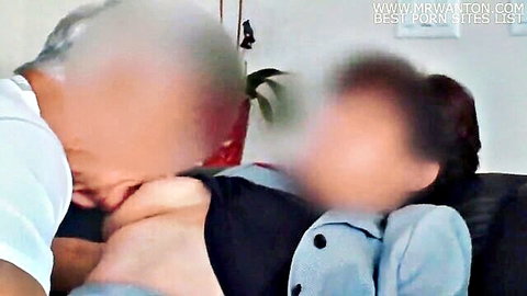 Mature balding man performs cunnilingus on young woman's spread pussy in amateur homemade