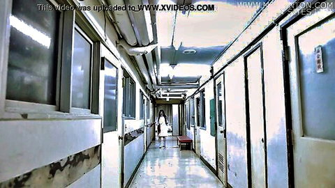 Sexy Japanese nurse in tight white uniform walking down dimly lit hospital hallway teasing viewers