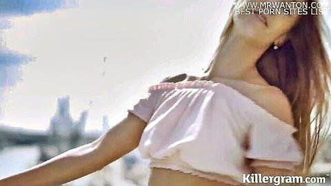 Alexis Crystal in pink off-shoulder top, long hair, sunny outdoor pose