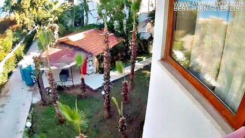 Tropical outdoor resort with palm trees red-roof hut and sunny garden perfect for public sex