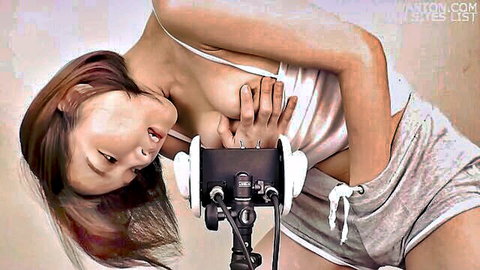 Seductive Asian JAV star in ASMR pose with deep cleavage and headphones