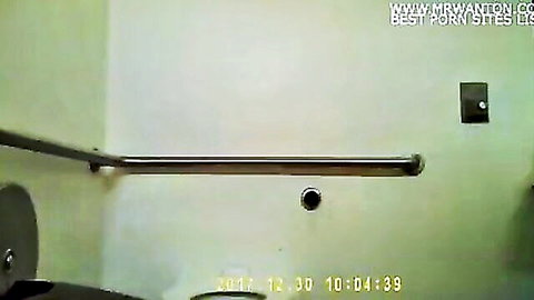 Voyeur bathroom stall with toilet and handrail, hidden cam style