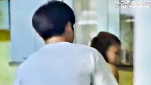 Blurry amateur East Asian couple posing intimately in bathroom mirror reflection