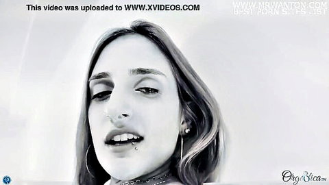 Seductive Caucasian woman with lip piercing and long hair teases close-up, Orgastica TV
