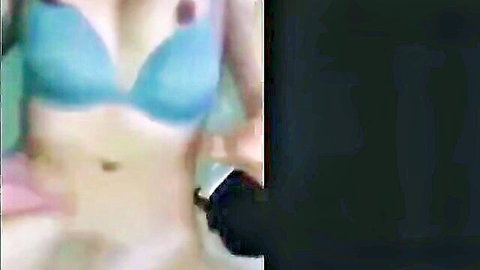 Blurry Filipina in blue bra with hand near navel, teasing pleasure
