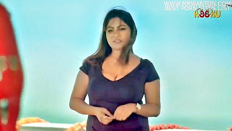 Busty Indian housewife in tight purple top showing deep cleavage outdoors