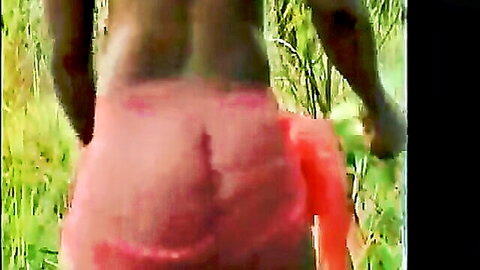 Ivory Coast Tassaba dancer's toned black ass in red cloth, cultural dance view