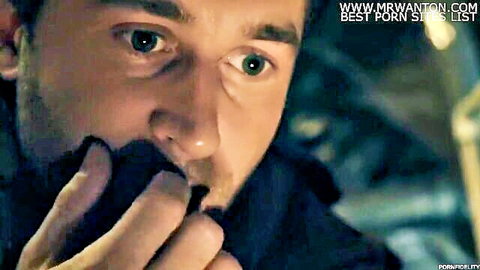 Stubbled man with piercing blue eyes sucks thick black cock intensely closeup