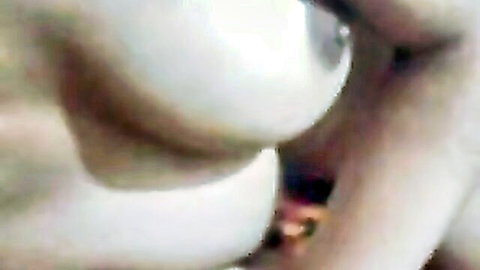 Close-up of big white tits with erect pinkish-brown nipples and deep cleavage