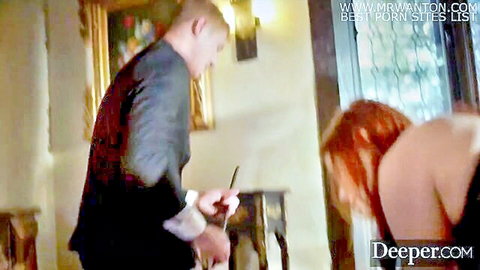 Maitland Ward in low-cut black dress bent over by suited man