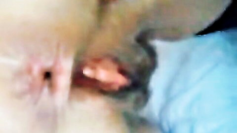 Close-up of spread hairy pussy exposing moist pink vaginal opening and labia