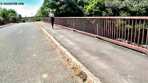 Sexy mature blonde MILF walks on bridge in tight white pants teasing ass