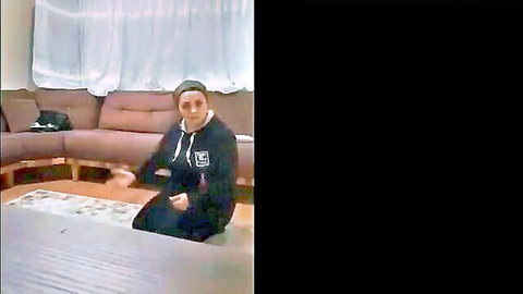 Skinny brunette Turkish girl kneeling seductively in black hoodie on living room floor
