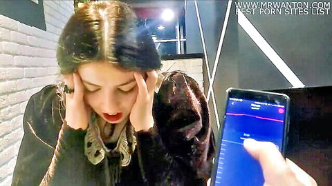 Brunette in velvet dress reacts intensely to Lovense Lush remote control