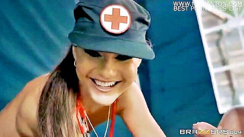 Smiling Asian nurse in sexy uniform showing deep cleavage