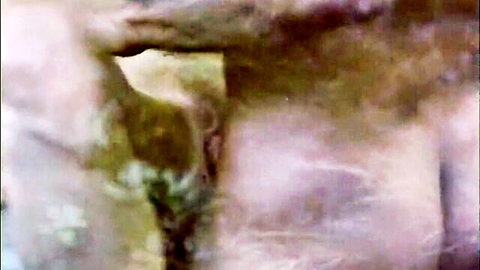 Blurry close-up of nude woman's fleshy curves and skin tones in explicit pose