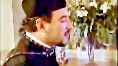 Priest in traditional black attire with white collar, profile view in serene setting