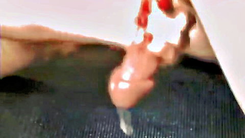 Close-up handjob climax with cumshot dripping from erect penis