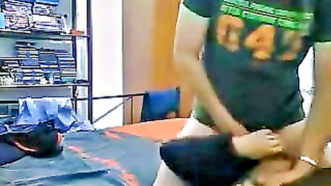 Guy in green shirt grips woman's thigh spreading her legs on bed missionary style