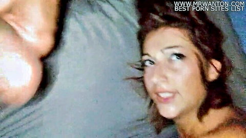 Brunette woman smiling seductively with cock near face in explicit oral scene