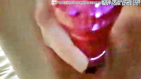 Close-up of woman masturbating with pink vibrator insertion