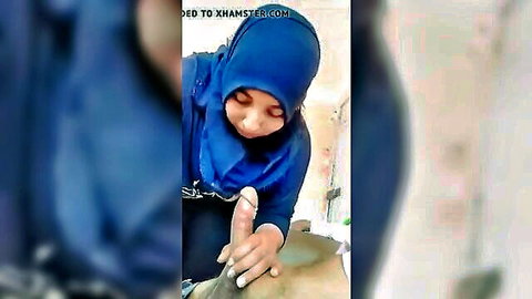 Blue hijab Arab woman smiles as fingers thrust into her wet exposed pussy