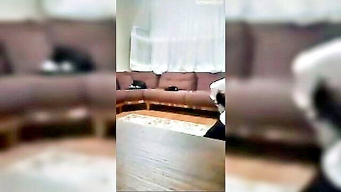 Blurry Turkish exorcism scene with woman in white robe on couch