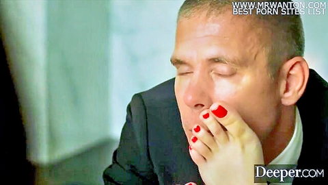 Husband in suit dominated by woman's red-toenailed foot, Deeper fetish scene