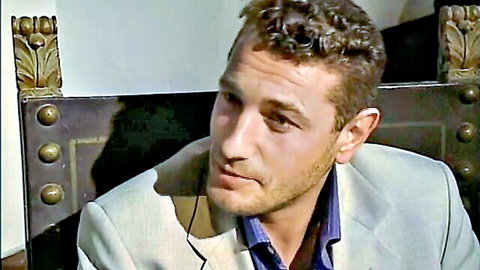 Curly-haired man in gray suit, intense gaze from Io La Monaca Di Monza adult film
