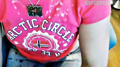 Hot girl in pink Arctic Circle t-shirt with cum stains on cleavage, teasing pose