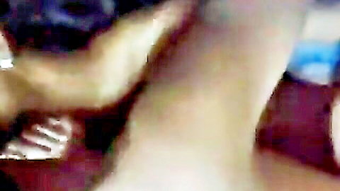 Blurry closeup of tanned South Asian legs and Nike shoe in dim amateur homemade scene