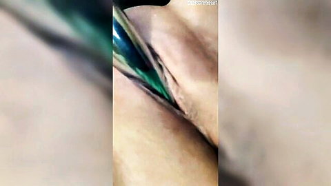 Close-up of pale-skinned woman with green dildo penetration in wet pussy