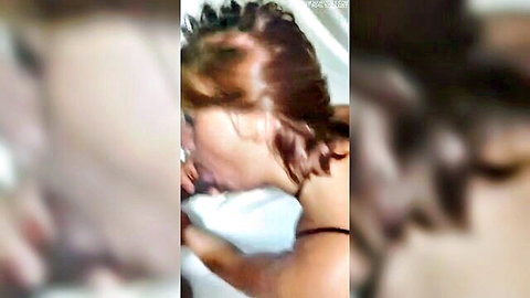 Redhead woman passionately French kissing boyfriend in shower closeup