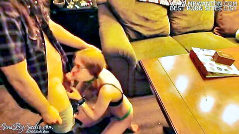 Freckled redhead gamer girl with glasses kneels sucking boyfriend's thick cock in living room