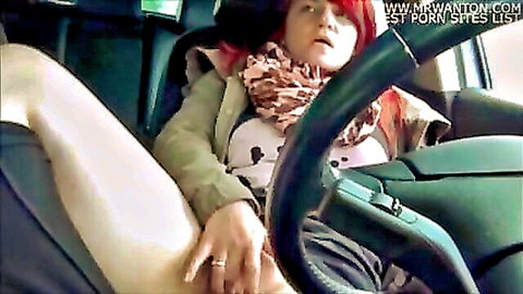 Redhead babe spreads legs and fingers wet pussy in car driver's seat