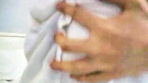 Blurry closeup of Japanese hand pulling white panties aside exposing shaved pussy lips