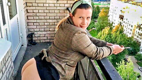 Blonde woman exposes big ass on balcony in plaid blazer tease