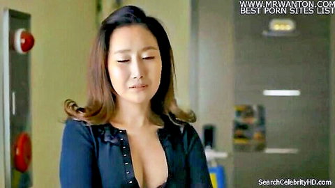 Young Korean woman showing deep cleavage in unbuttoned low-cut top gazing pensively