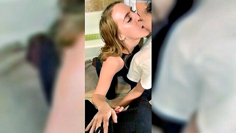 Blonde woman in black dress kissing man in house party threesome