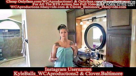 Tattooed brunette MILF wrapped in towel teases big tits in bathroom mirror