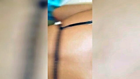 Blurry closeup of pale Caucasian babe's juicy ass in black thong from behind