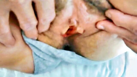 Blurry POV closeup of hands gripping woman's head forcing cock deep into her open mouth with blue collar.