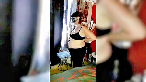 Pregnant BBW MILF in black bra and pants posing with mask