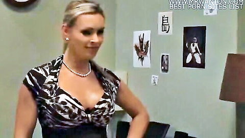 Blonde MILF smiles seductively showing deep cleavage in low-cut dress