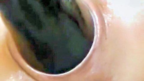 Extreme closeup of thick black dildo stretching and penetrating tight pink anus