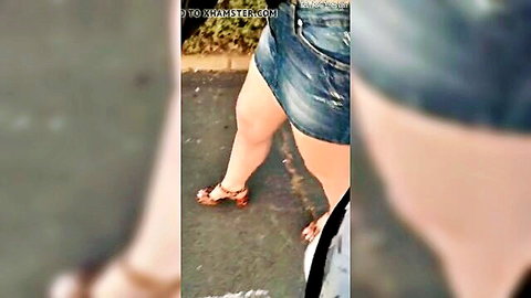 MILF in denim mini skirt showing sexy thick legs and feet in strappy heels